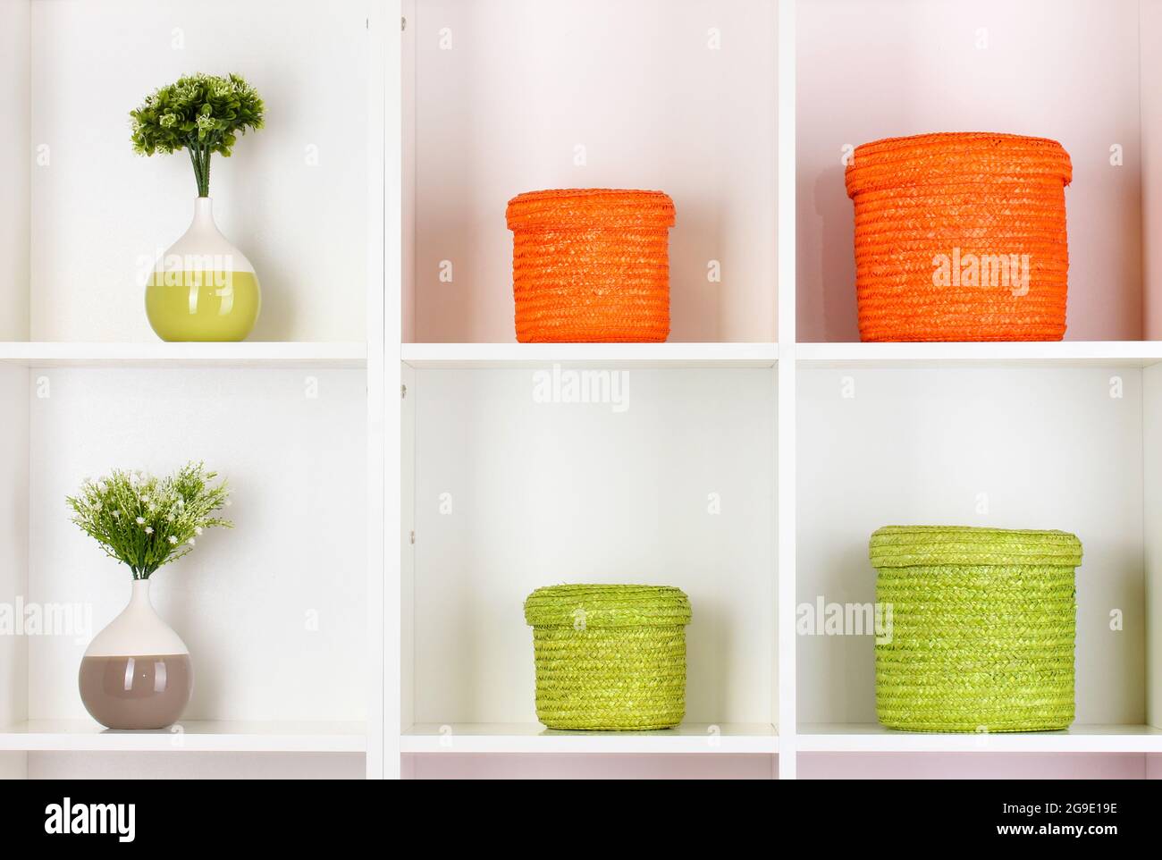 Color wicker boxes on shelves Stock Photo Alamy