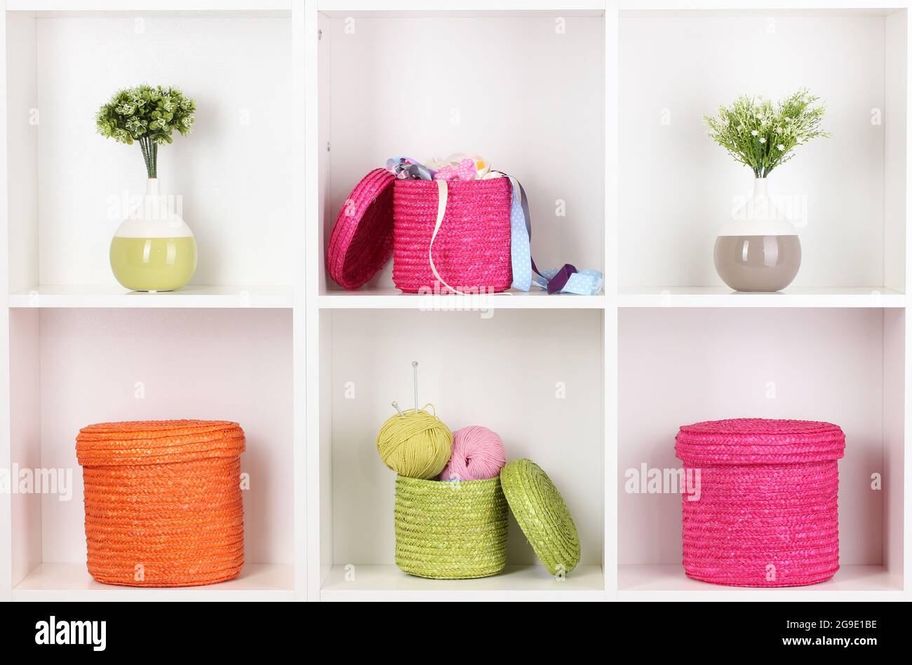 Color wicker boxes on shelves Stock Photo Alamy