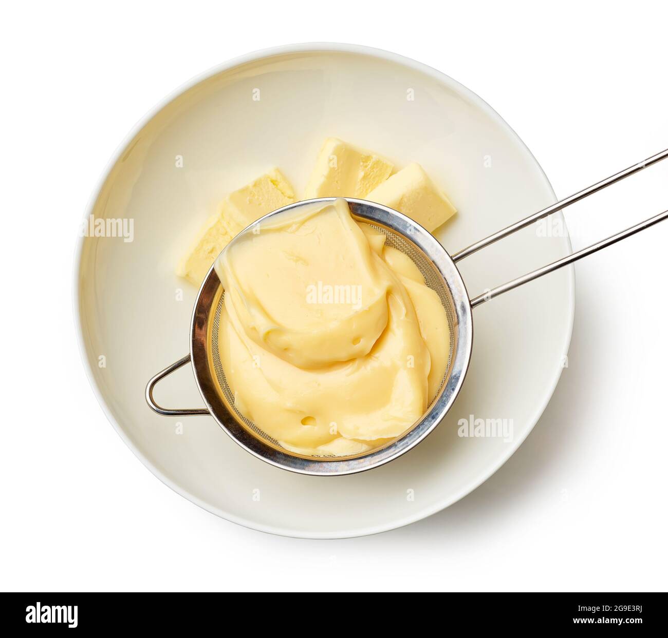 custard cream in a strainer. chef adds custard cream to butter in a bowl isolated on white background, top view Stock Photo