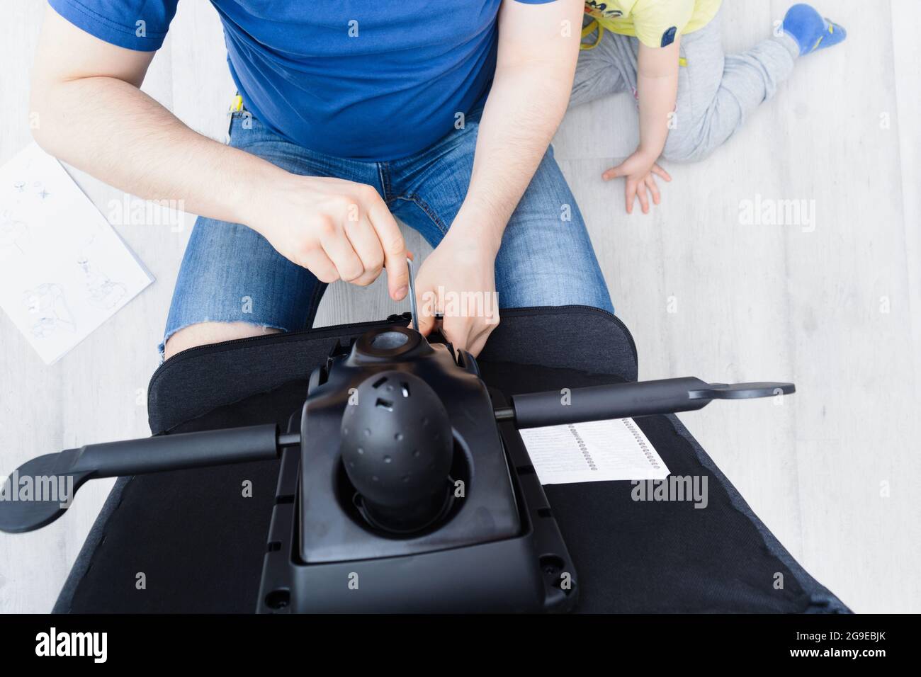 Assembling office chair indoors. Step by step instructions. Step 12 Stock Photo