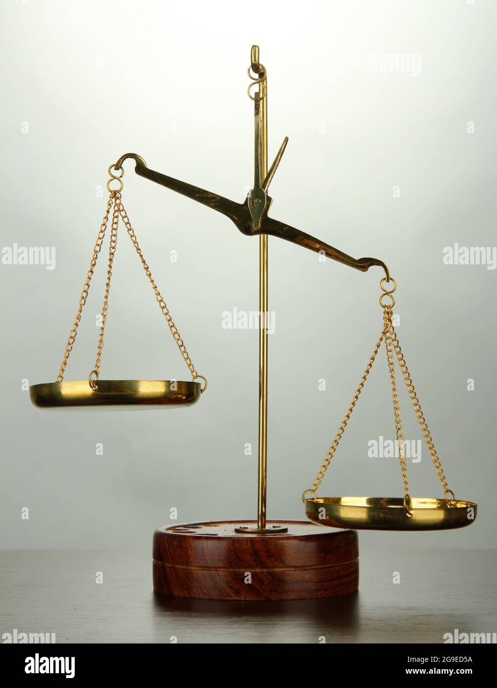 Gold scales of justice on grey background Stock Photo - Alamy