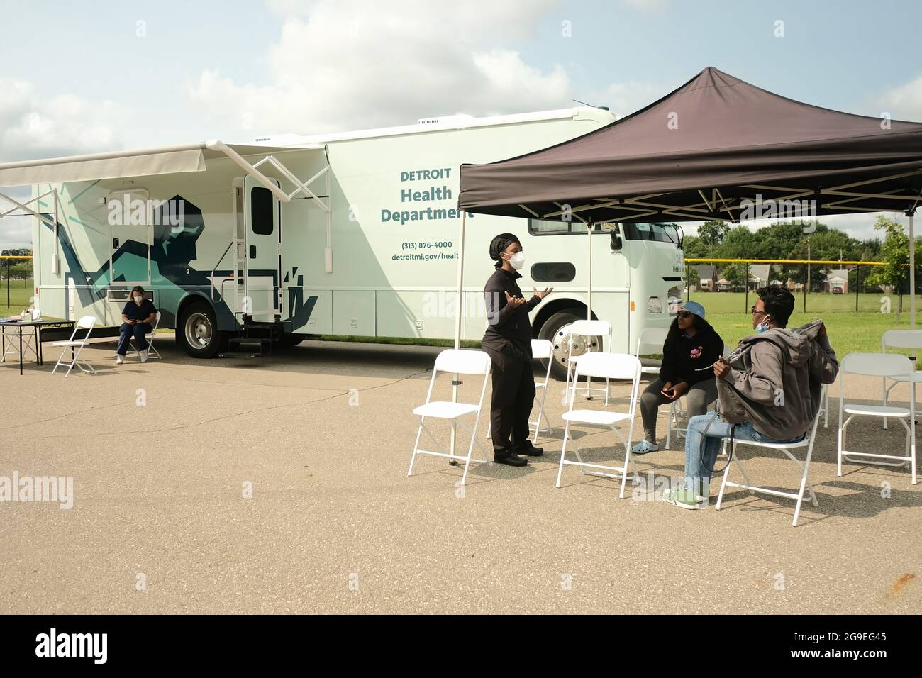 Detroit, Michigan, USA. 21st July, 2021. A health care worker from the Detroit Health Department briefs a patient on what to expect after receiving a Pfizer Vaccine during a mobile vaccination clinic at East English Village High School.Vaccination Clinics are being held at various dates through the rest of July and into August at 3 different public high schools in Detroit, Michigan. The clinics are part of an effort between the Detroit Health Department and the Detroit Public Schools Community District to administer as many vaccines as they can prior to the coming school year, and to Stock Photo