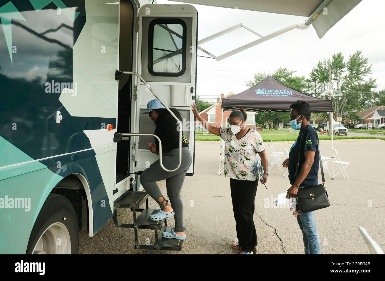 Detroit, Michigan, USA. 21st July, 2021. Health Care Workers from the Detroit Health Department get a patient checked in and prepared to receive a dose of the Pfizer vaccine during a mobile vaccination clinic at East English Village High School.Vaccination Clinics are being held at various dates through the rest of July and into August at 3 different public high schools in Detroit, Michigan. The clinics are part of an effort between the Detroit Health Department and the Detroit Public Schools Community District to administer as many vaccines as they can prior to the coming school year Stock Photo