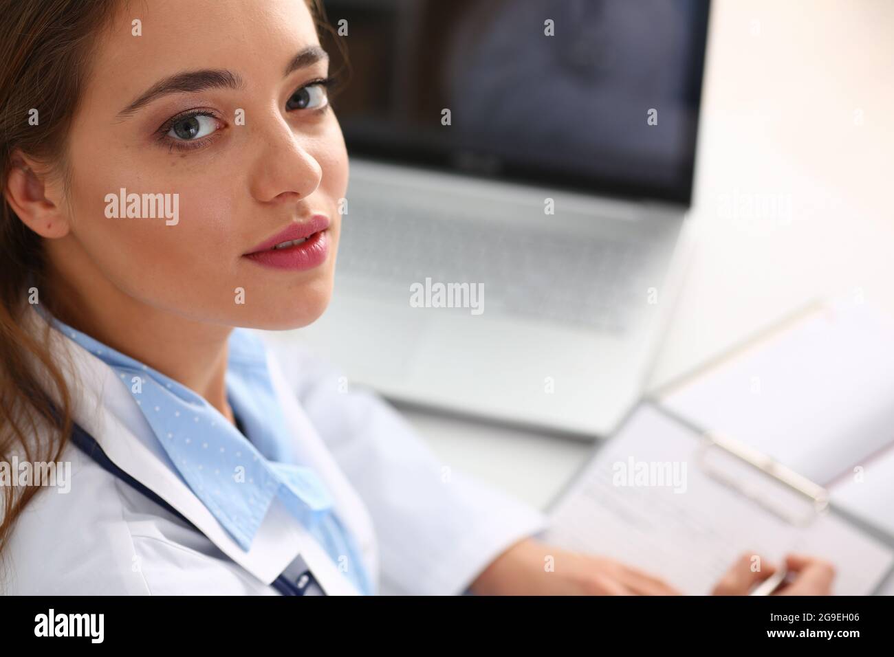 Beautiful smiling female doctor write prescription Stock Photo - Alamy