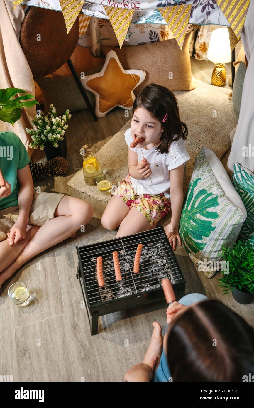 Top view of girl eating sausage with her family Stock Photo Alamy