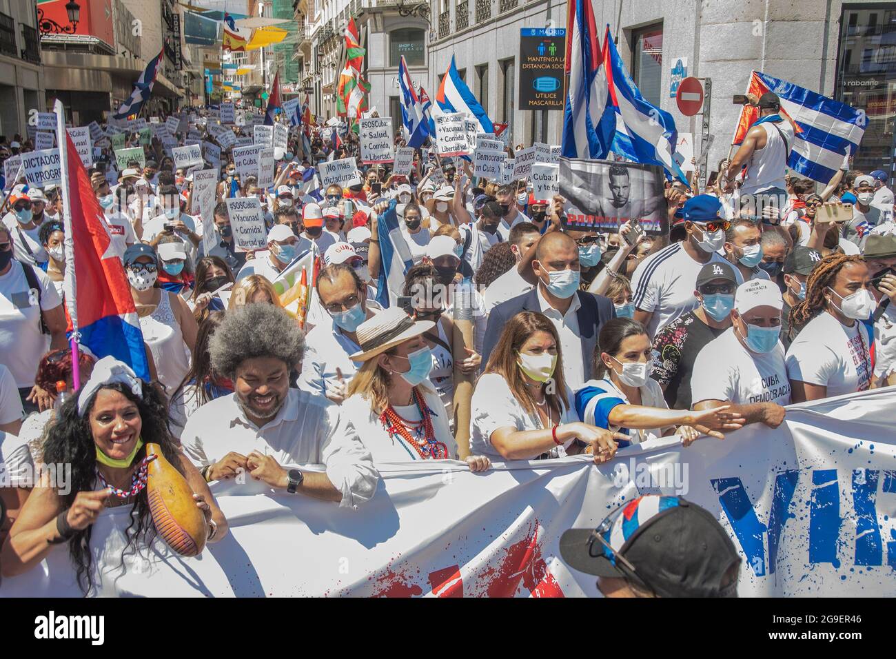 In the picture the Cuban singer, actor Yotuel Romero and the leader of the ultra right wing party Rocio Monasterio. Hundreds of people have taken the center of Madrid this Sunday in support of the Cuban people and asking for their freedom with the slogan 'The hour of freedom has arrived. If Cuba is on the street, so are we.' The protesters, including the leader of the Popular Party, Pablo Casado, and the leader of Vox in Madrid, Rocio Monasterio, have marched from Cibeles to the Plaza de Callao, shouting slogans such as 'Sanchez, say it, a dictatorship', 'Assassins' and 'Freedom'. (Photo by Al Stock Photo