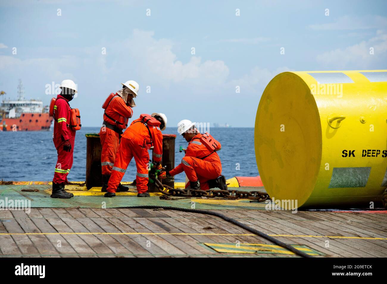 marine crew working on deck during cargo handling operation for jack up