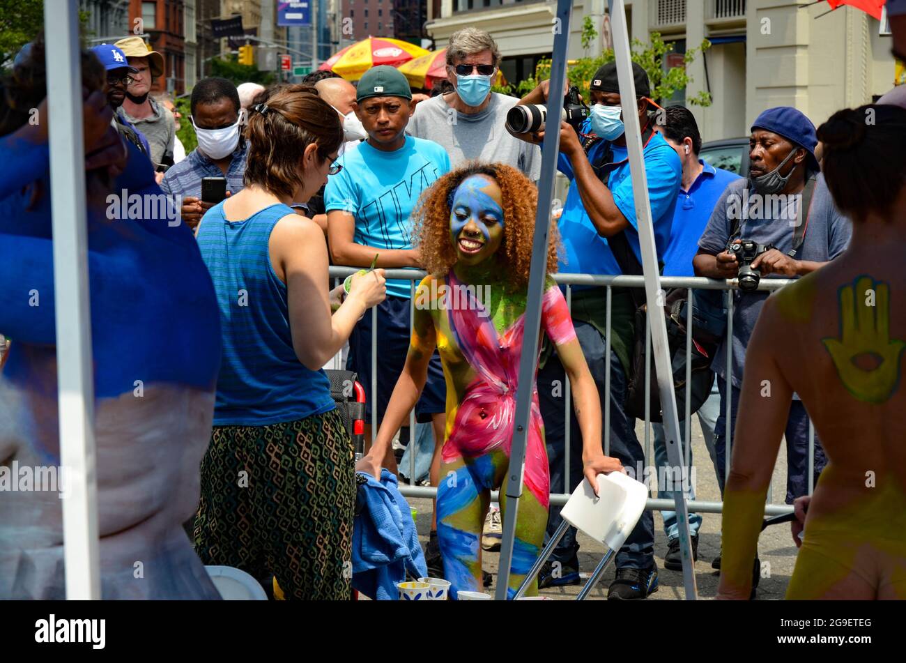 A young Participant is being painted during the annual bodypainting day in New York City, July