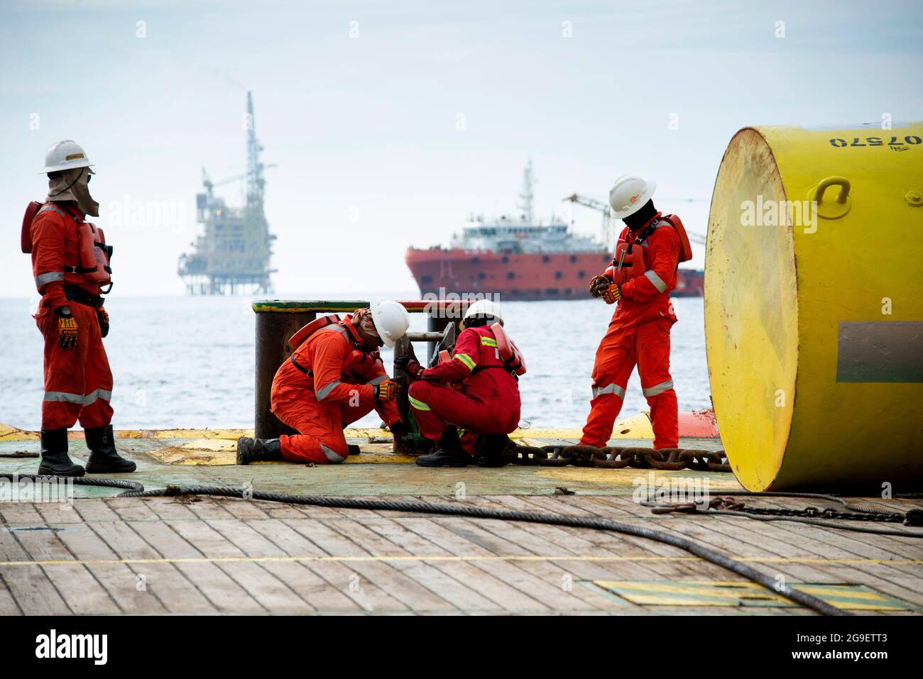 marine crew working on deck during cargo handling operation for jack up