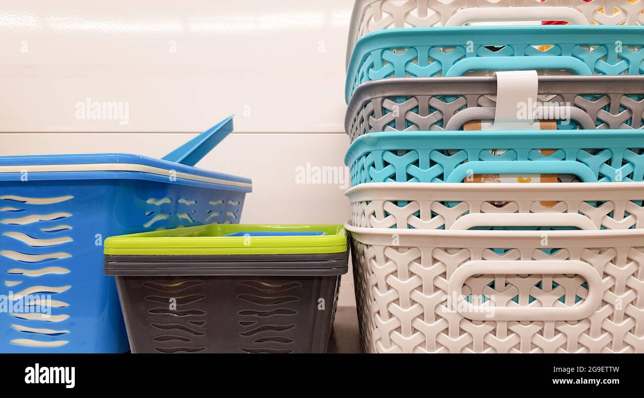 Plastic containers of different colors and prices are placed in a warehouse or store on display