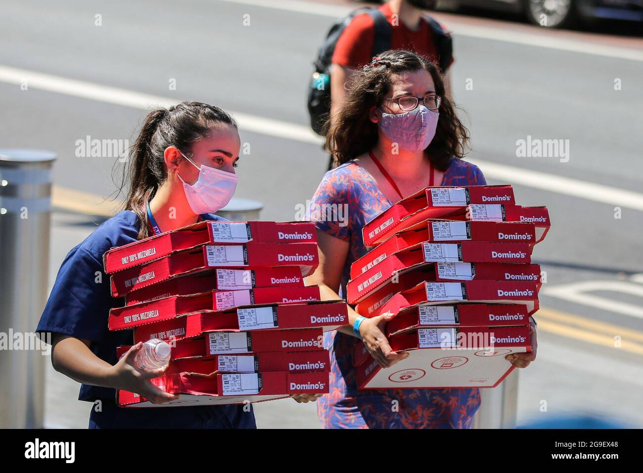 London, UK. 18th July, 2021. Women wearing face masks carry boxes of Domino's Pizza in London. (Credit Image: © Dinendra Haria/SOPA Images via ZUMA Press Wire) Stock Photo