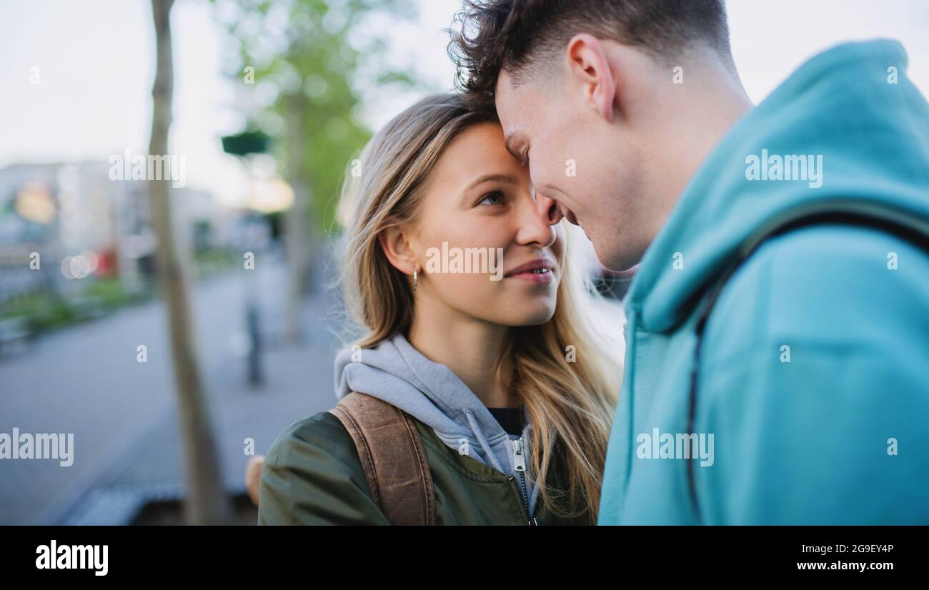 Happy young couple travelers in love in city on holiday, hugging. Stock Photo