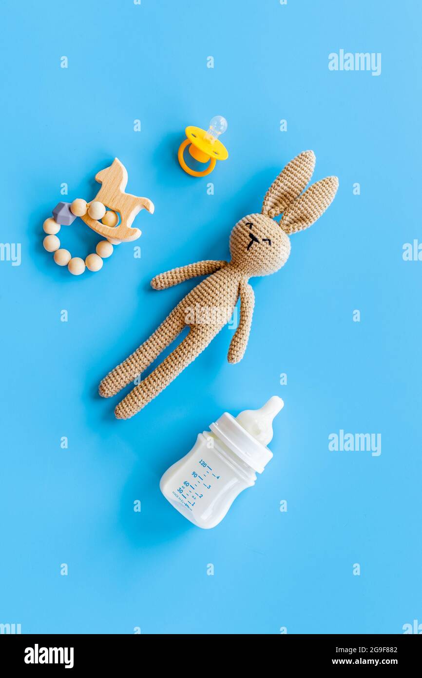 Knitted baby toy rabbit for newborn with wooden toys, top view Stock ...