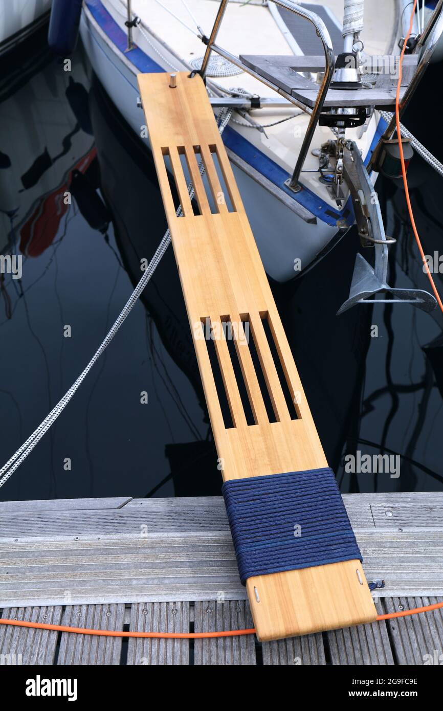 Sailing in Dubrovnik, Croatia. Sailing yacht wooden boarding gangway (gangplank) mounted to the front of the boat in a marina. Stock Photo