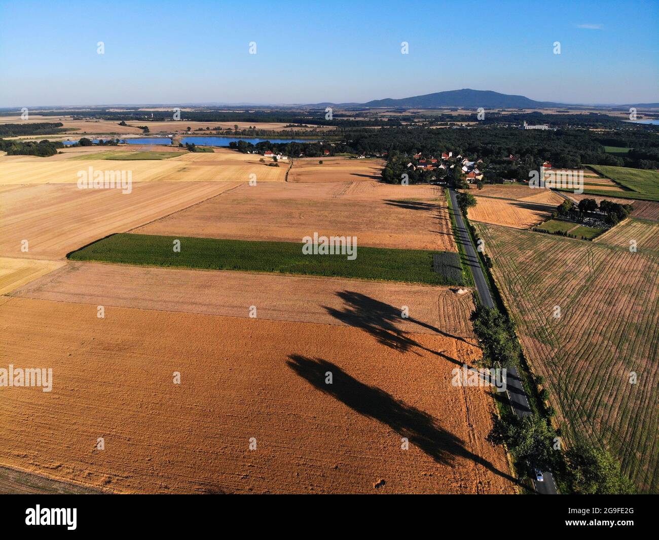 Agriculture landscape in Poland. Harvest time fields view in Lower Silesia (Dolnoslaskie) province. Sleza mountain in background. Stock Photo