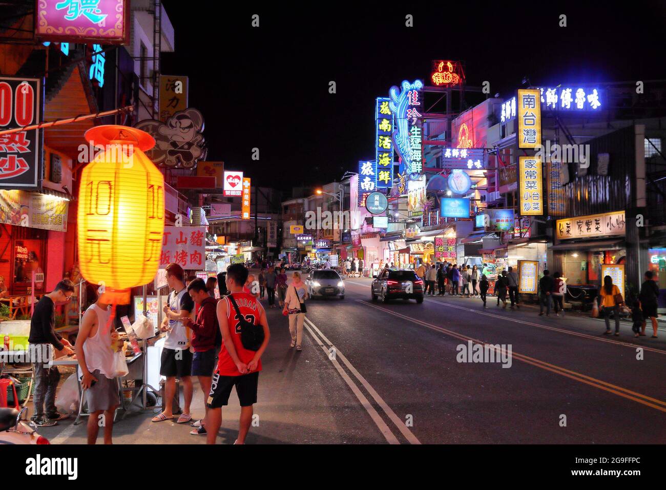 KENTING, TAIWAN - NOVEMBER 26, 2018: People visit Kenting Street Night Market in Taiwan. Night food markets are a big part of Taiwanese culture. Stock Photo