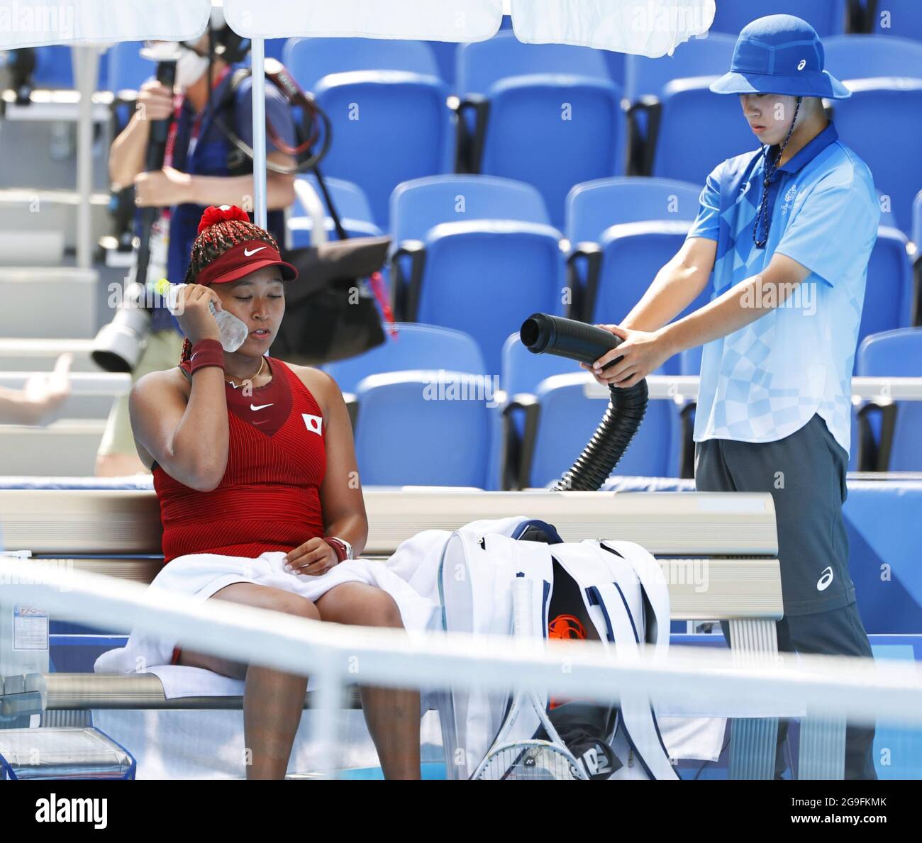 Naomi Osaka of Japan rests during her first-round match of the Tokyo Olympics amid a scorching heat wave at Ariake Tennis Park on July 25, 2021. (Kyodo)==Kyodo Photo via Newscom Stock Photo