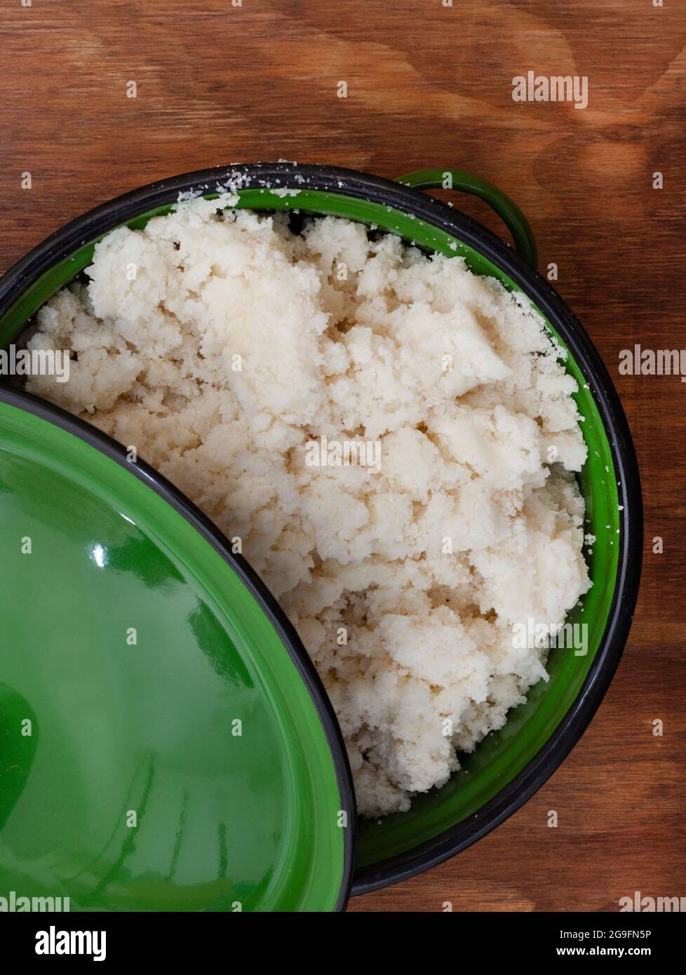 Traditional South African Maize meal in rustic green pot Stock Photo