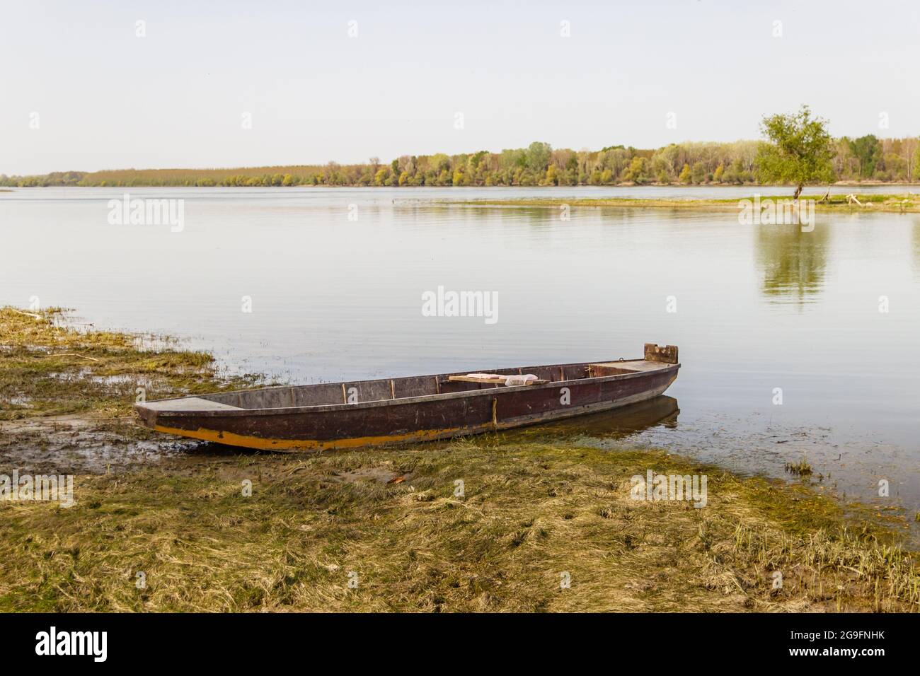 Old wooden row boat anchored on the shore Stock Photo - Alamy