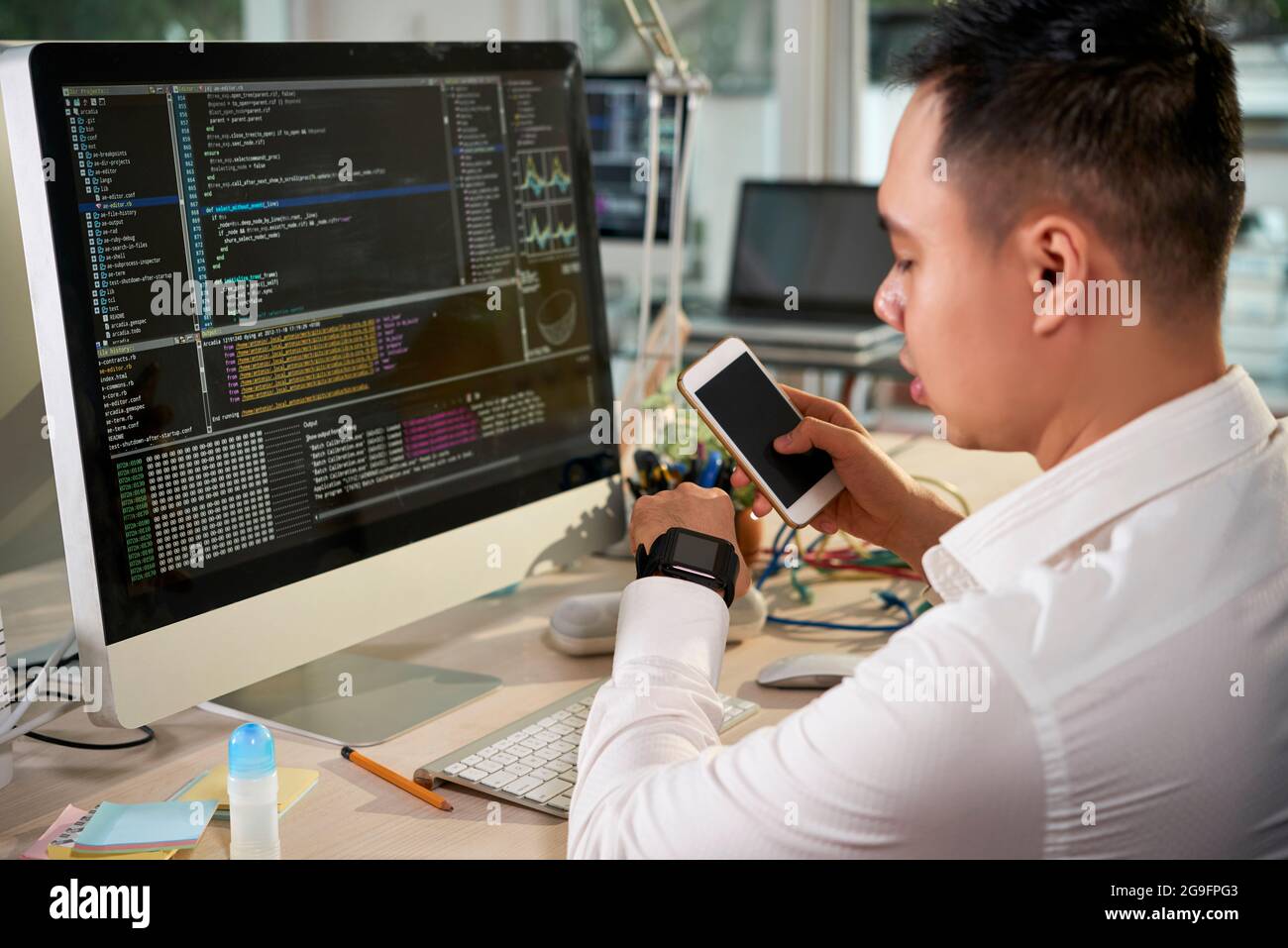 Software developer testing how the application he created is working on ...