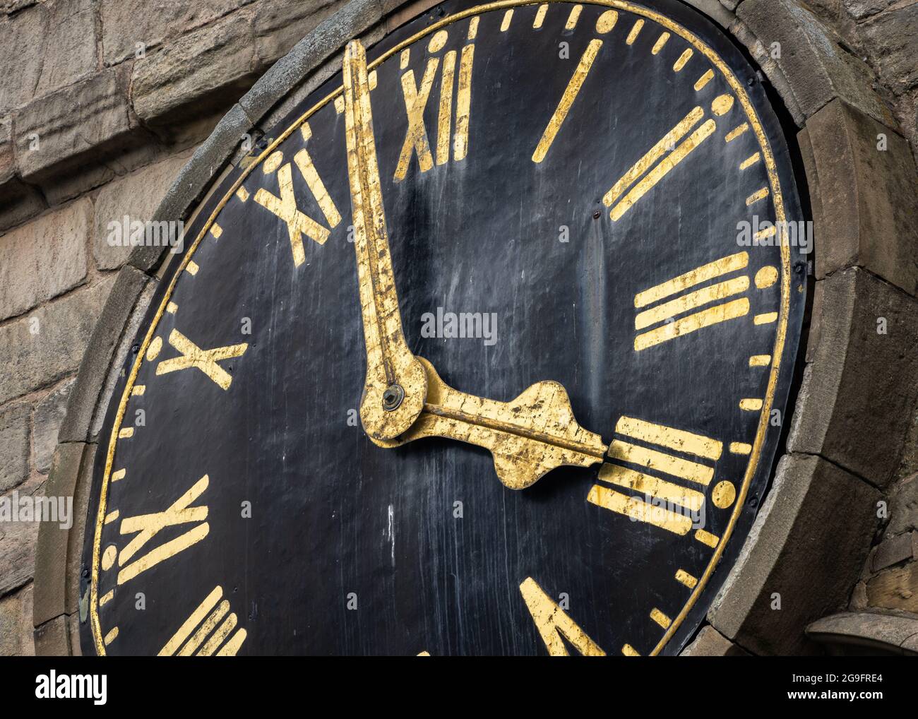 Vintage old church clock face of chesterfield crooked spire with gold