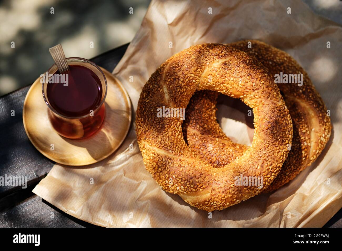 Traditional Turkish sesame bagel simit and Turkish tea on wood ...