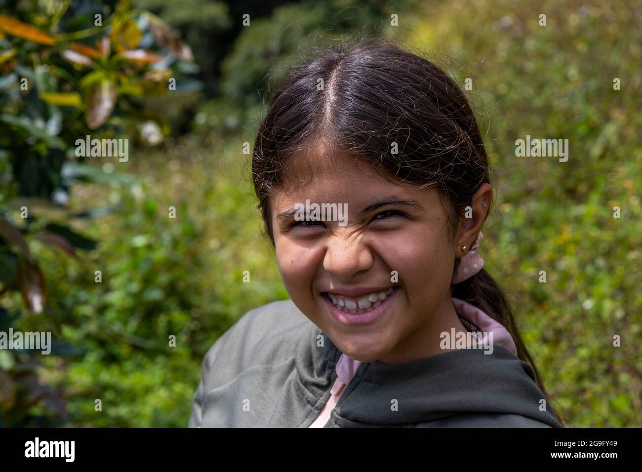 hispanic girl smiling in the country side Stock Photo