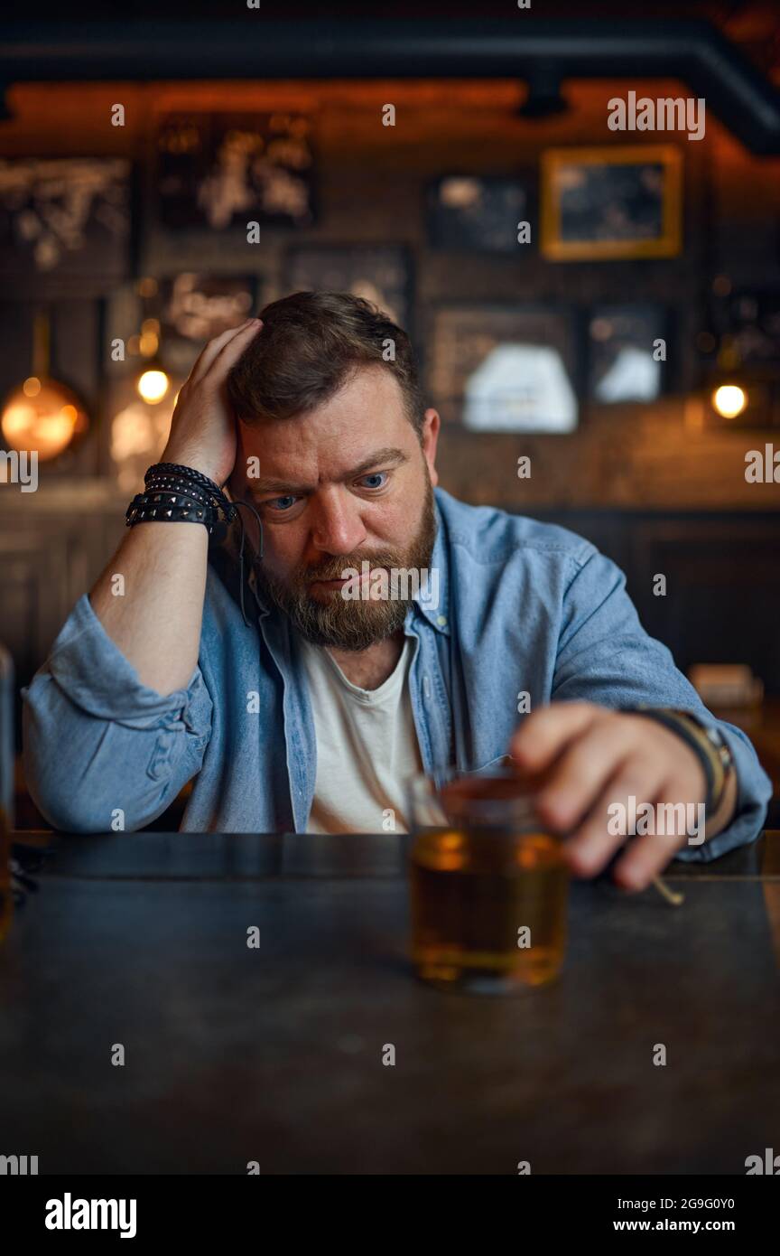 Drunk man pours alcohol at the counter in bar Stock Photo Alamy