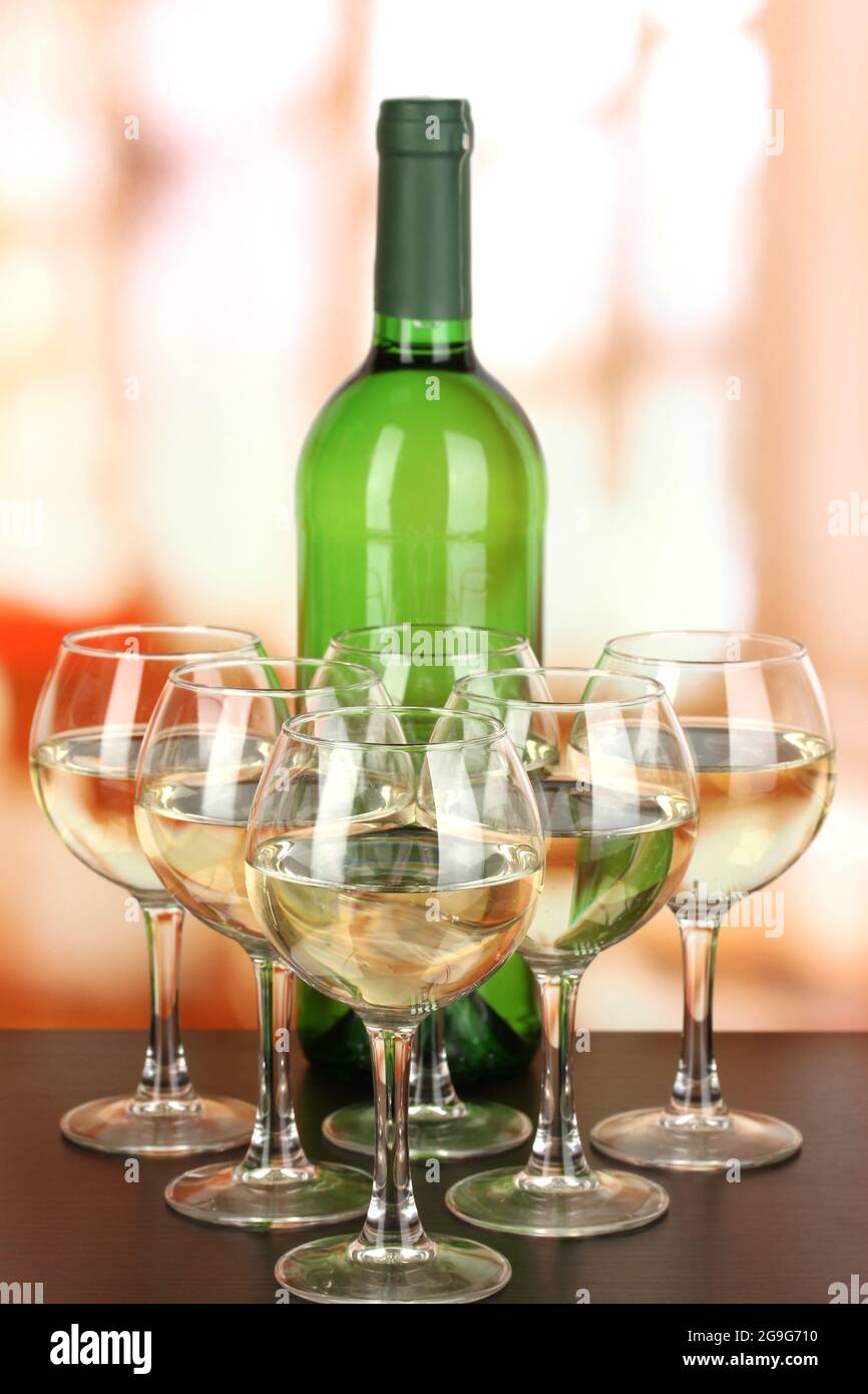 White wine in glass and bottle on room background Stock Photo Alamy