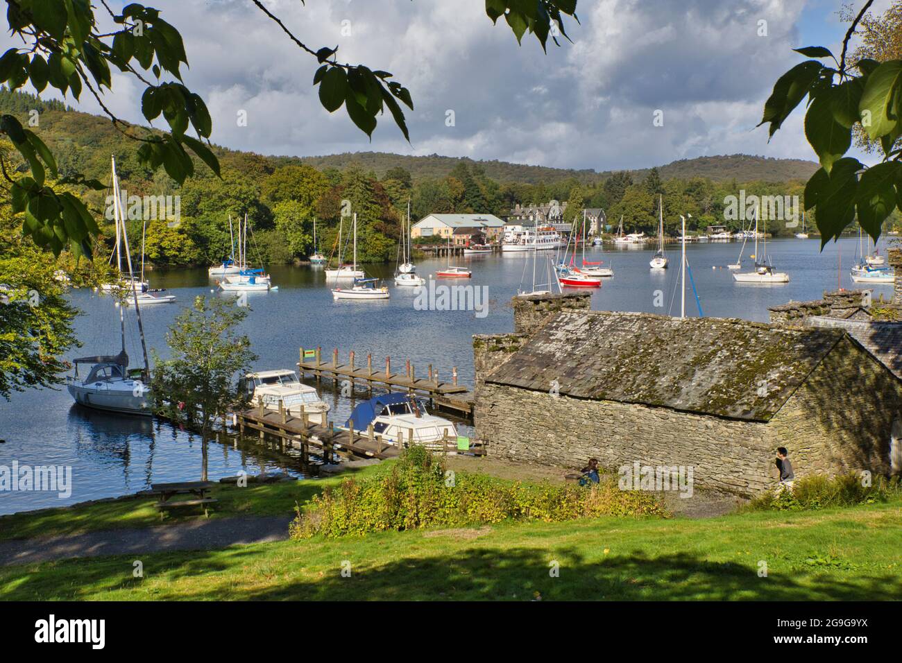 A lakeside scene with boats on their moorings in the Lake District, Cumbria, England, UK Stock Photo