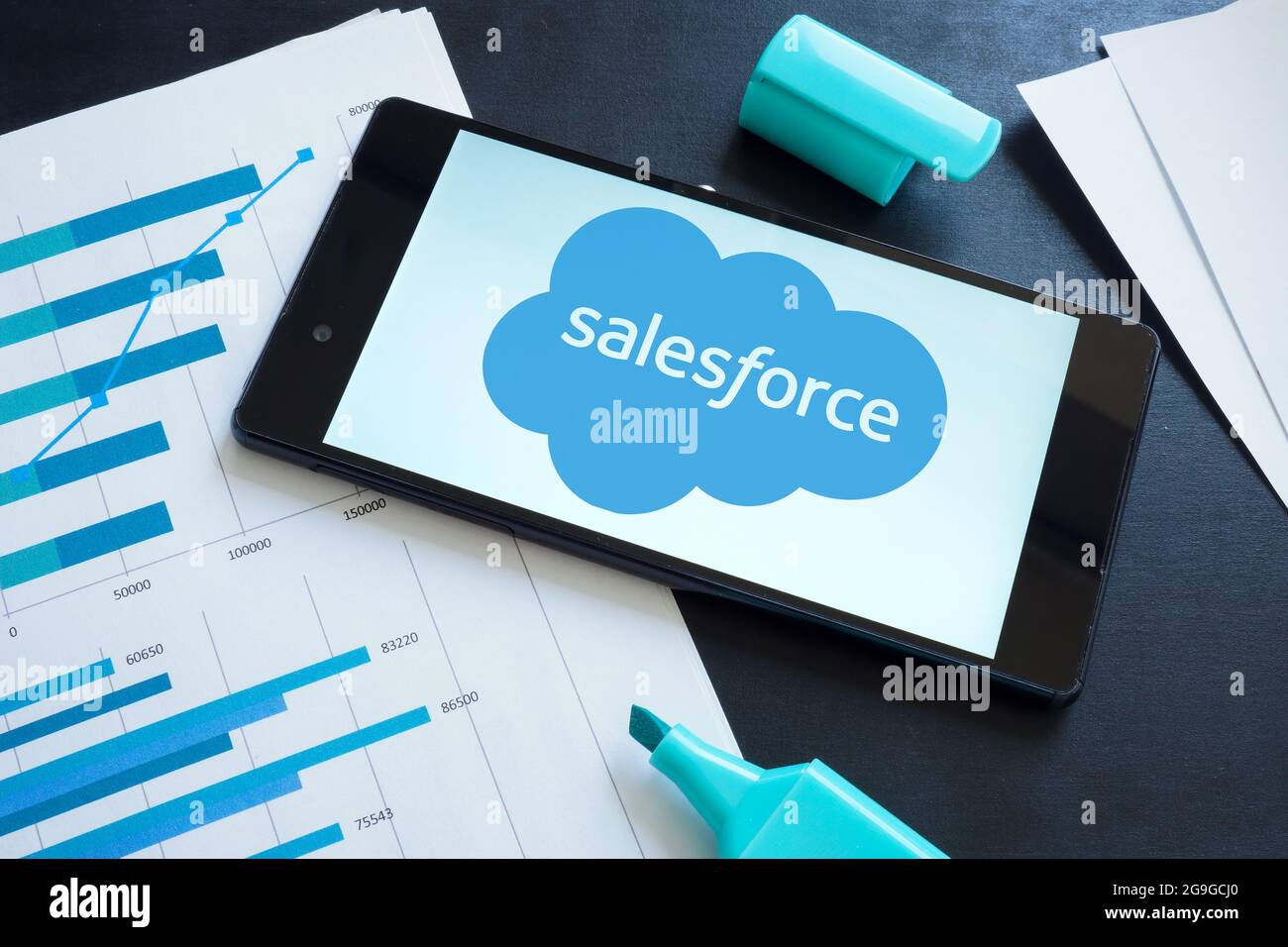 KYIV, UKRAINE - June 30, 2021. Salesforce logo on the smartphone and papers. Stock Photo