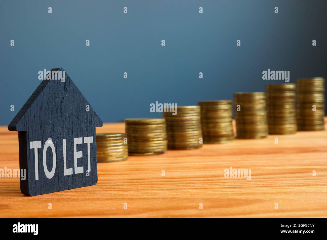 Buy to let on the small house and coins. Stock Photo