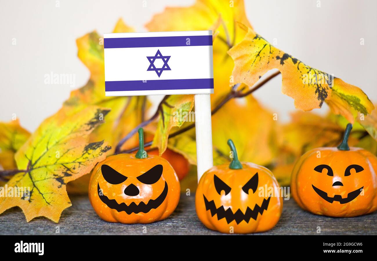 Colorful Halloween background with smiley pumpkins and toy flag of