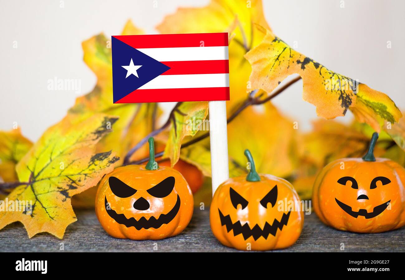 Colorful Halloween background with smiley pumpkins and toy flag of