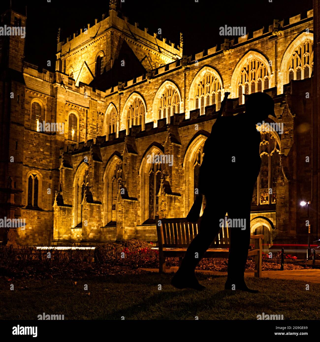 a silhouette of a World War 1 soldier outside an illuminated Ripon Cathedral Stock Photo
