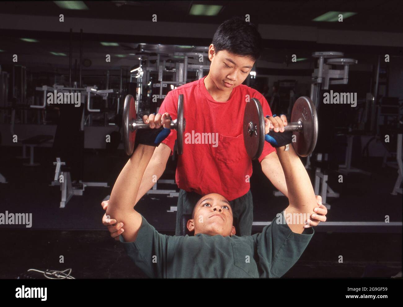 Teenage boy lifting weights hi-res stock photography and images - Alamy