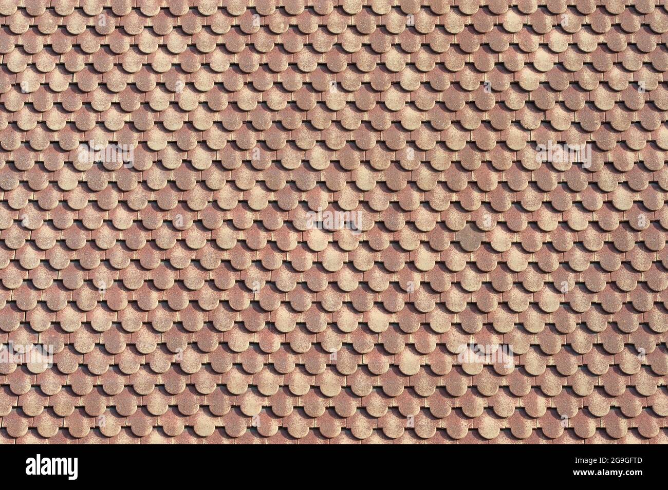 background of scalloped red clay roofing tiles Stock Photo