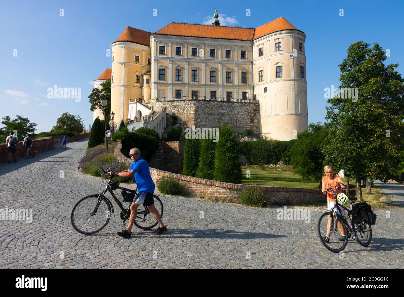 Tourists pushing bikes Mikulov Castle Czech Republic tourism Europe Stock Photo