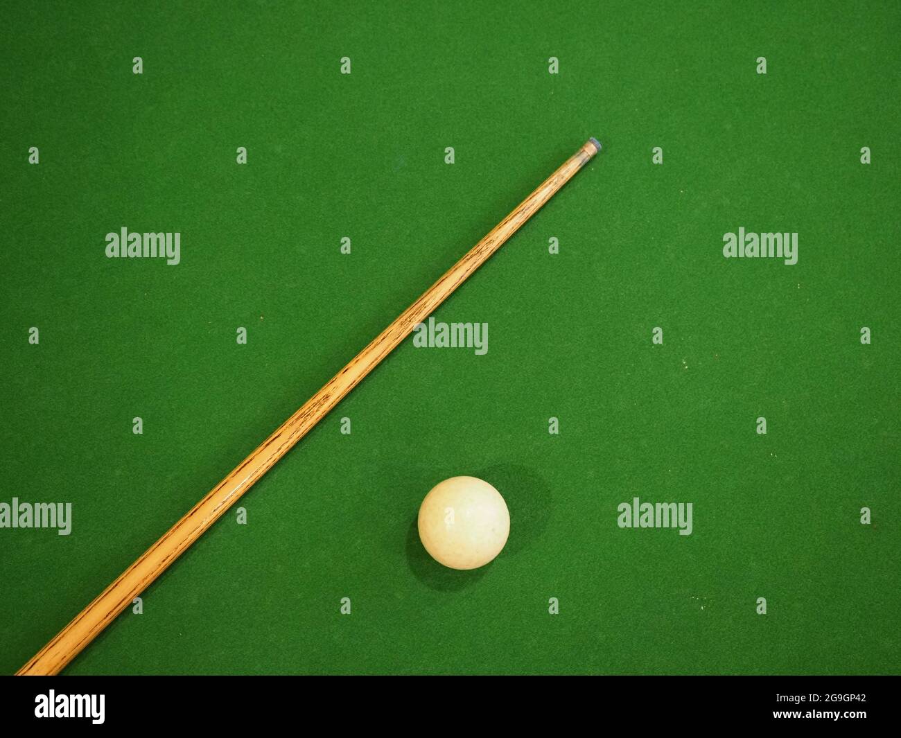 Sports game of billiards on a green cloth. one cue and a cue ball on a