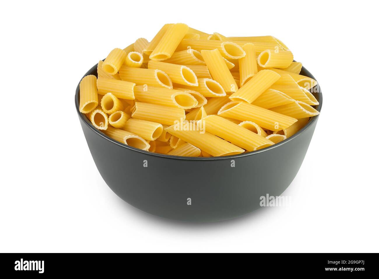 Raw italian penne rigate pasta in black bowl isolated on white background with clipping path and full depth of field Stock Photo