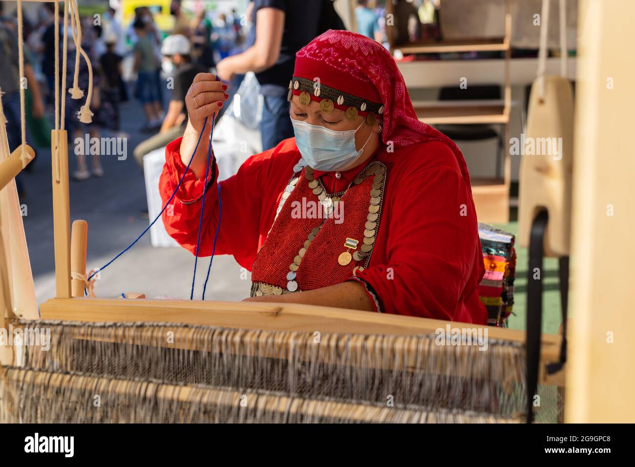 UFA, RUSSIA JULY 10, 2021 Bashkir woman make carpet during