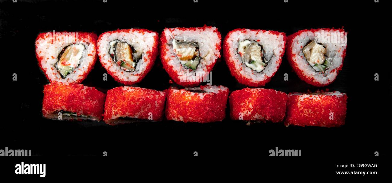 red triangular japanese rolls top view on a black background Stock ...