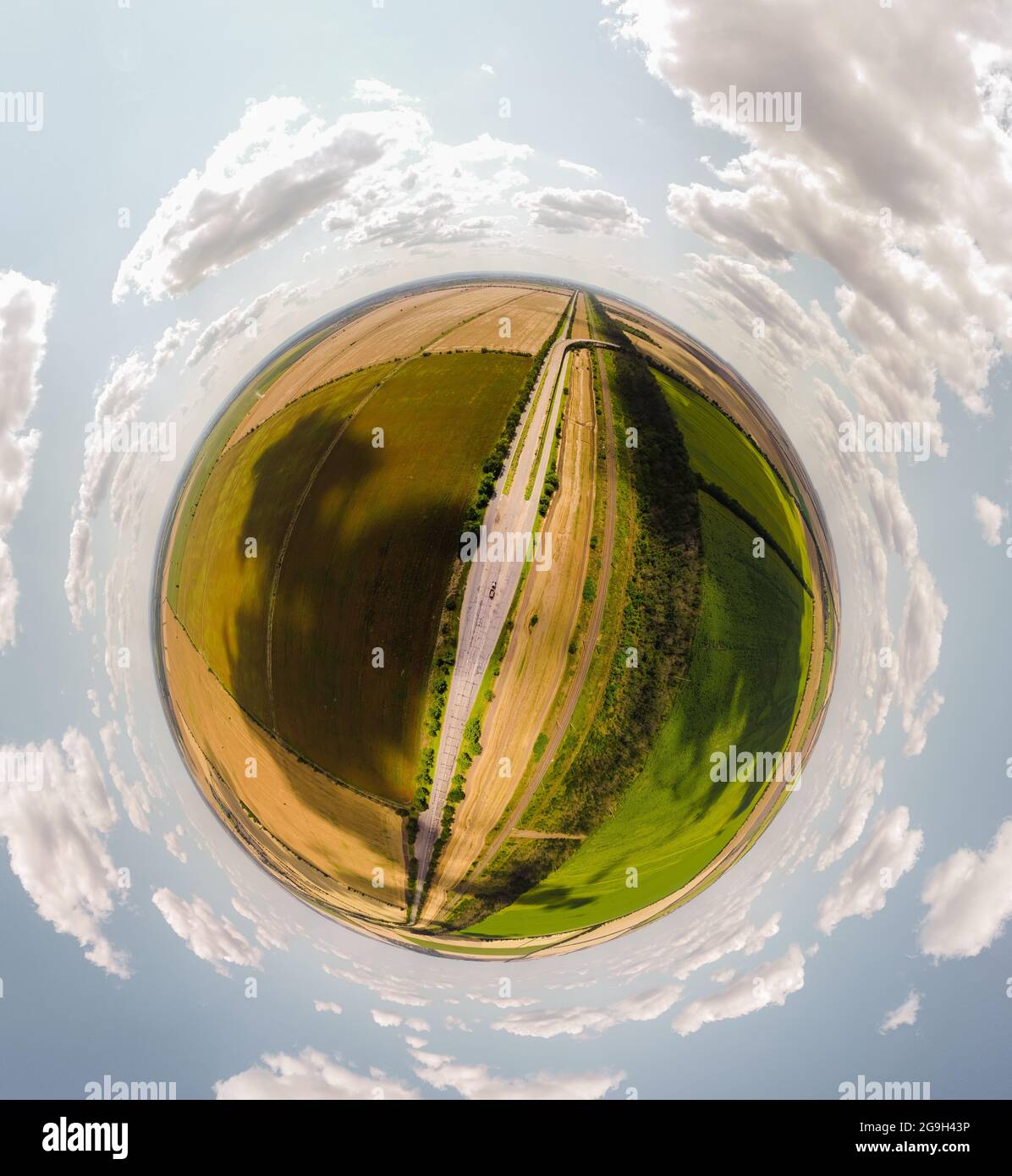 Small planet with a view of a bridge and wheatfields under the blue sky in Moldova, spherical panorama on DJi Mavic Mini 2 Stock Photo