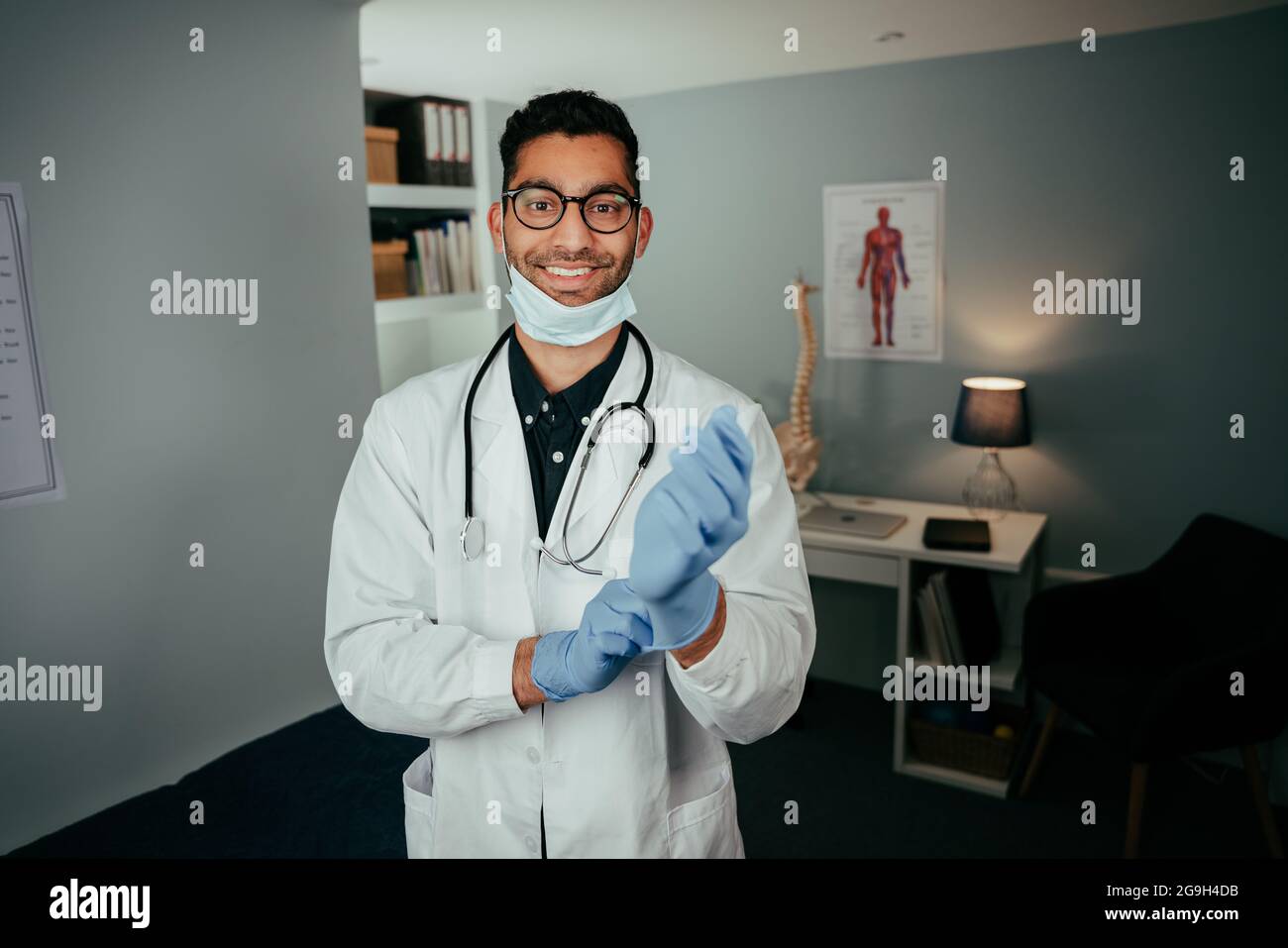 Mixed race professional doctor working in clinic smiling Stock Photo