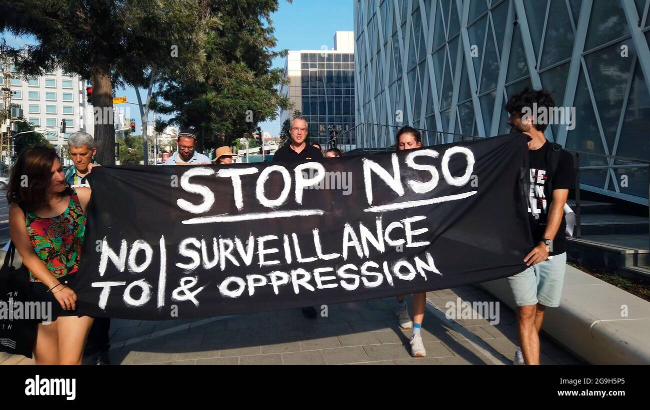 A black banner is held up saying 'Stop NSO' as Israeli activists take part in a protest calling for accountability and increased controls on the international sale of spyware technology in front of the building housing the Israeli NSO group whose spyware called Pegasus enables the remote surveillance of smartphones on July 25, 2021, in Herzliya, Israel. Stock Photo