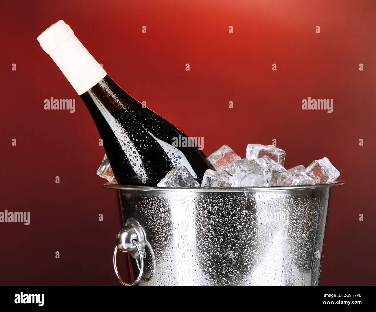 Bottle of wine in ice bucket on darck red background Stock Photo Alamy