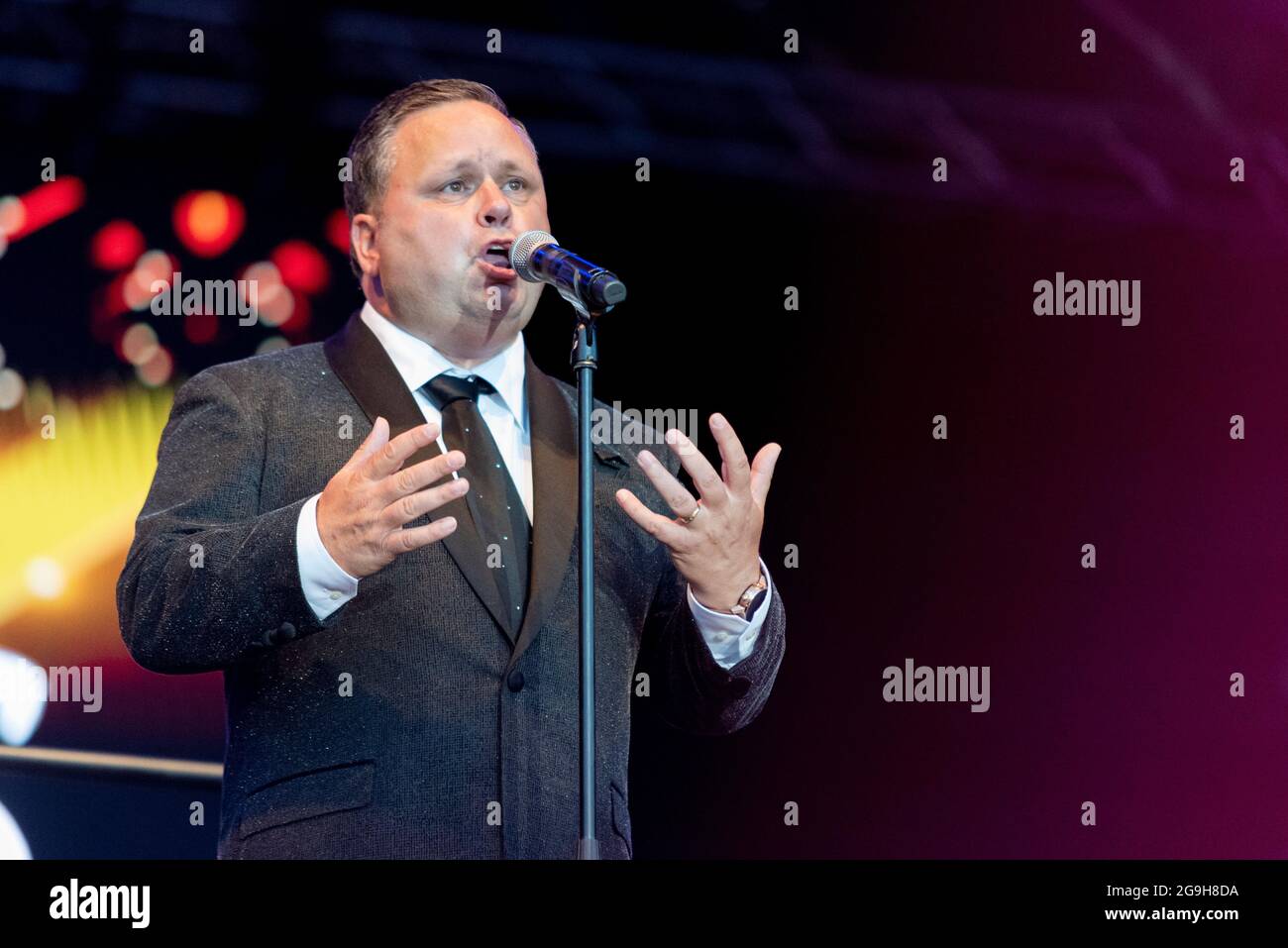 Paul Potts performing on stage in Maldon, Essex, UK. Welsh male operatic tenor singer, singing with the London Concert Orchestra after COVID lockdown Stock Photo