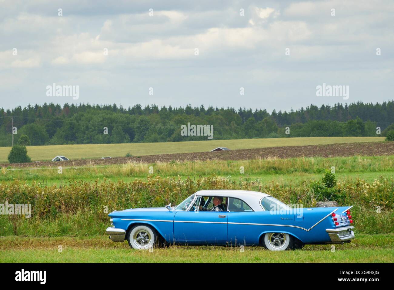 Old classic Vintage car driving in the countryside Stock Photo - Alamy