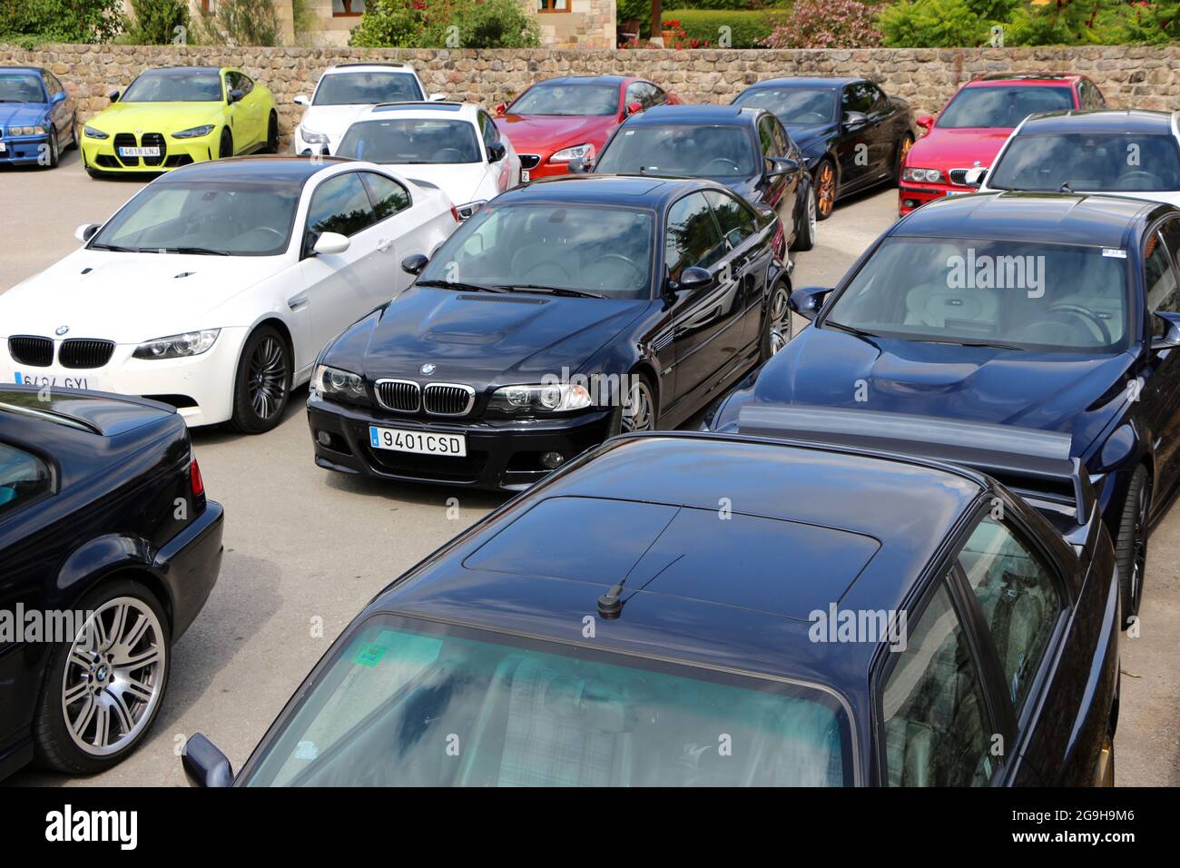 A collection of BMW M performance cars in a car park at an owners