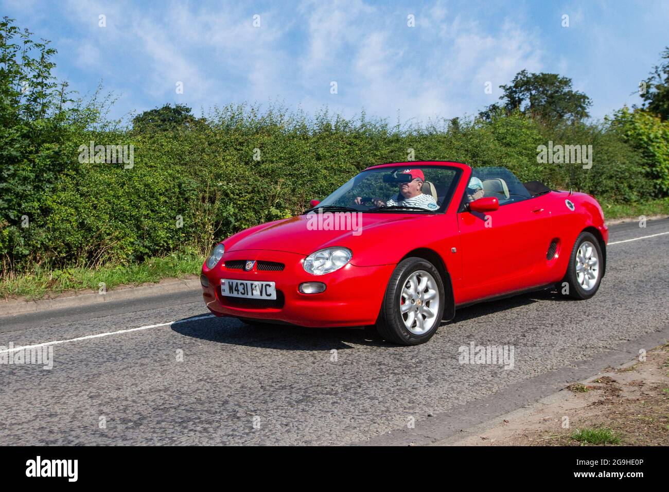 2000 red MG VVC 5 speed manual 1796cc petrol cabrio, en-route to Capesthorne Hall classic July car show, Cheshire, UK Stock Photo